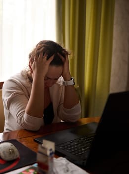 Overworked woman putting hands on her head, feeling tension headache while telecommuting on laptop from hone office. Business, stress, people, depression, pressure, career, crisis, problems concept