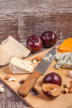Gourmet delicatessen on wooden background. Healthy food. Differet type of cheese on wooden background.