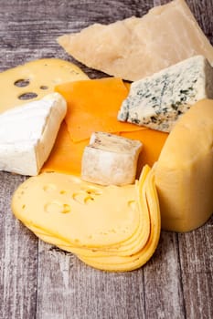 Different type of cheese on wooden background. Gourmet food apetizer