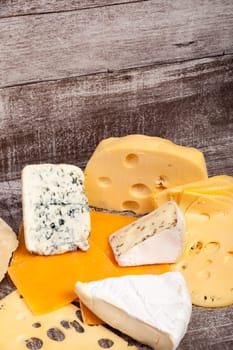 Different type of cheese on wooden background. Gourmet food apetizer