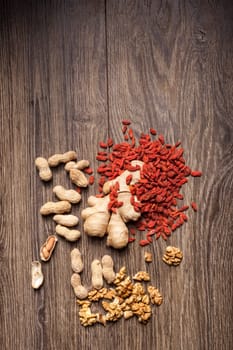 Dried fruits and nuts on wooden background. Healthy food