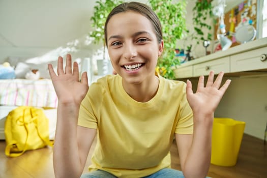 Adolescent teenage girl student having video conference chat call. Talking laughing having fun female teenager looking at webcam. Young vlogger recording video content. Technology, adolescence