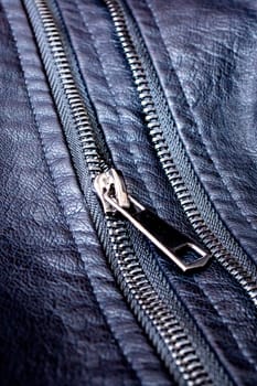 Zipper and rivets on black leather clothes close up