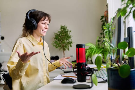 Teenage female student studying online at home, female in headphones with notebook talking to teacher by video, using computer. Chat call conference, e-learning college high school, technology concept