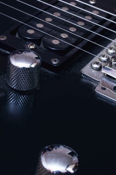 Switches on a black electric guitar close up