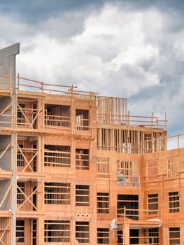 Apartment building under construction on cloudy sky background.