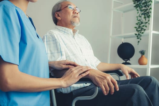 Caring nurse and a contented senior man in a wheel chair at home, nursing house. Medical for elderly patient, home care for pensioners.