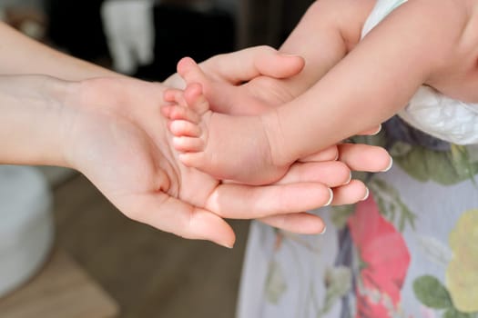 Newborn baby feet in mom's hands. Infancy, motherhood, parenthood, love, family concept