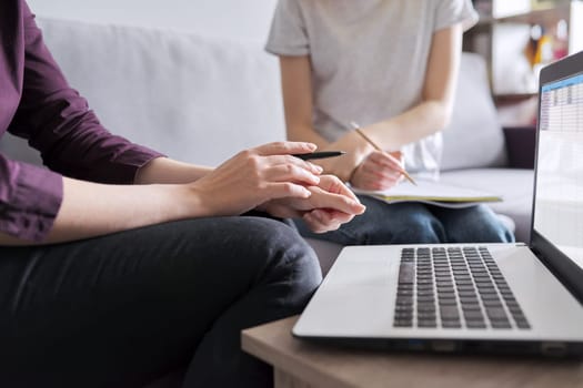 Close-up of student studying individually with teacher, focus on teacher hands with laptop. Education, mentoring, individual lessons, school and college concept