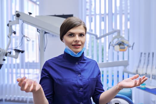 Video call, telemedicine, video consultation on the site, modern technologies in dentistry medicine. Female doctor dentist talking looking at webcam, close up, dental clinic office background