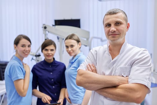 Team of colleagues dentists, portrait of doctors looking at the camera in dental office. Staff, medicine, dentistry and health care