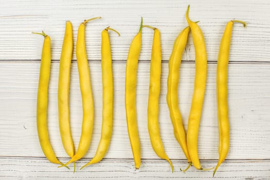 Tabletop view - yellow string (wax) beans on white boards. 