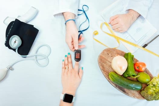 Nutritionist measuring oxygen pulse to patient, Close up of hands of nutritionist using pulse oximeter on patient finger.  Concept of nutritionist using oximeter on finger of female patient