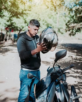 Man on motorcycle putting on helmet. Person on motorcycle putting on safety helmet. Biker motorcycle safety concept. Young motorcyclist man putting on safety helmet