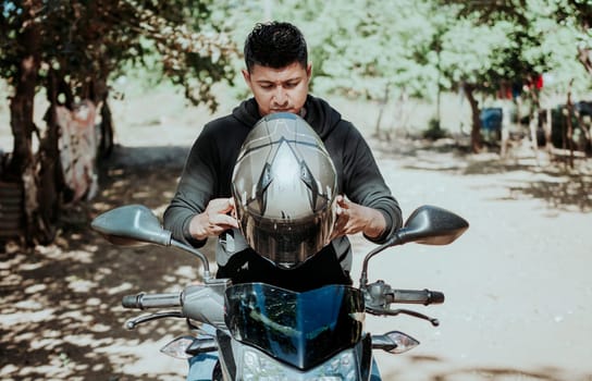 Man on motorcycle putting on helmet. Motorcyclist putting on safety helmet, Biker motorcycle safety concept. Young motorcyclist man putting on safety helmet