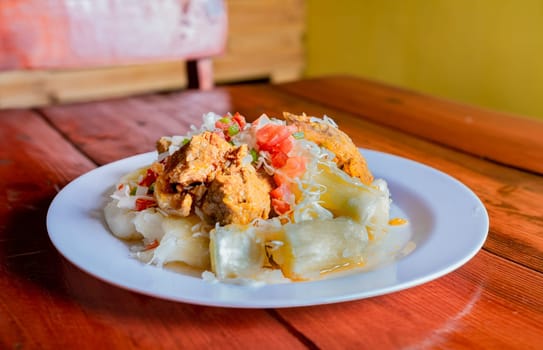 Traditional Chancho dish with Yuca. Nicaraguan pork with yucca served on wooden table