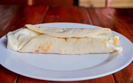 Traditional cheese dish with pickled onion and cream. Traditional Cheese with Pickled Onion,  Concept of typical foods of latin america