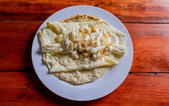 Top View of traditional Cheese with Pickled Onion, Traditional cheese dish with pickled onion and cream. Concept of typical foods of latin america