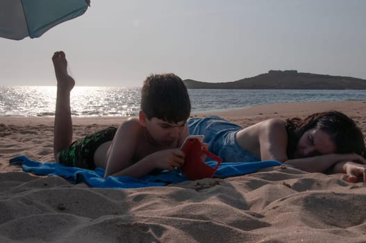 Mother and son relax a beach. Summer lifestyle concept.