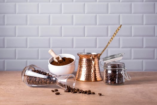 Coffee beans and ground coffee in glass and porcelain containers. Traditional Turkish cezve. Coffee break. Selective focus.