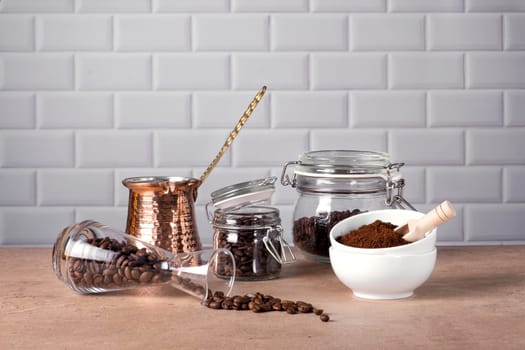 Coffee beans and ground coffee in glass and porcelain containers. Traditional Turkish cezve. Coffee break. Selective focus.