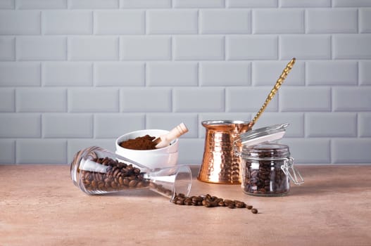 Coffee beans and ground coffee in glass and porcelain containers. Traditional Turkish cezve. Coffee break. Selective focus.