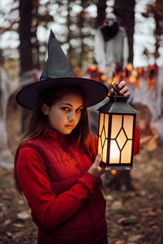 Small girl with lantern in forest with a ghost on the background