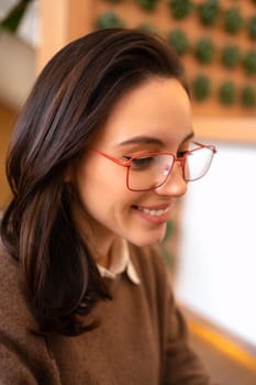 Middle age beautiful businesswoman wearing glasses close up side view portrait looking to side, relax profile pose with natural face and confident smile. Vertical high angle view