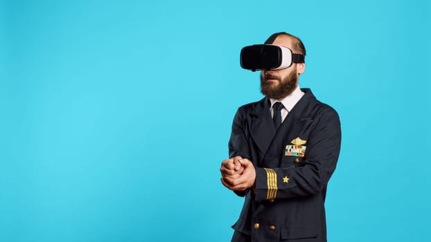 Airplane pilot using vr headset with interactive vision, having fun with virtual reality glasses. Young airline captain with aviaton uniform using 3d simulation gadget, aircrew.