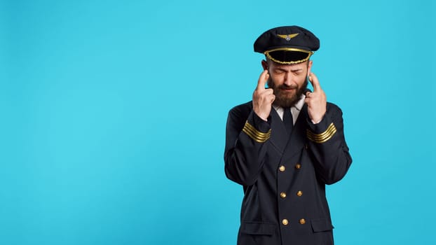 Hopeful airplane pilot posing with fingers crossed to fulfill wish, preparing for commercial flight work. Cabin captain praying for luck and fortune, acting wishful and having beliefs.