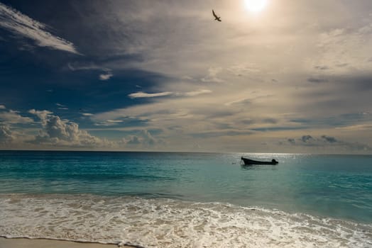 The boat in the Caribbean Sea on a sunny day. Clear water.