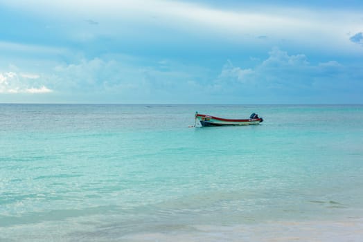 The boat in the Caribbean Sea on a sunny day. Clear water.