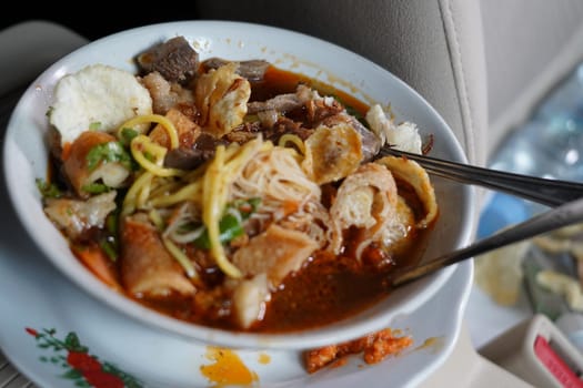 Soto Mie Bogor or Noodle soup with spring rolls from Bogor is authentic indonesian traditional food. Shot in the car.