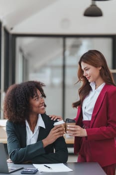 Multiethnic business people meeting and communicating at coffee break. Tax, exchange, accounting and financial advisor.