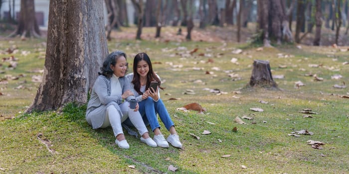 Adult daughter and her elderly mother have outdoor activity together.