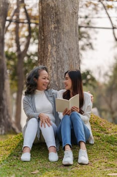 Adult daughter and her elderly mother have outdoor activity together.