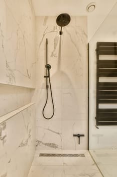 a modern bathroom with marble tiles and black shower head mounted on the wall next to the toilet in the room
