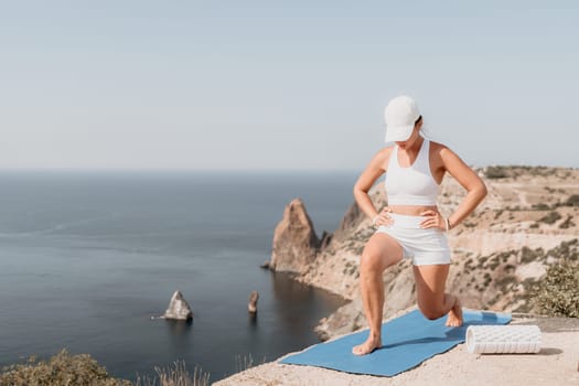 Fitness woman sea. Outdoor workout with fitness rubber bands in park over beach. Female fitness pilates yoga routine concept. Healthy lifestyle. Happy fit woman exercising with rubber band in park