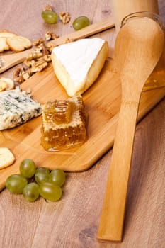 Cheese apetizer on wooden background. Rustic food