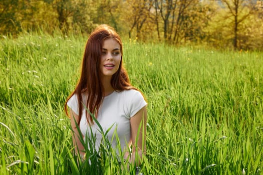 happy cheerful woman laying in green grass. High quality photo