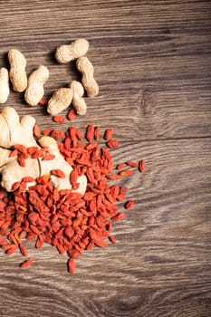 Raw organic food and nuts on wooden background. Over top view