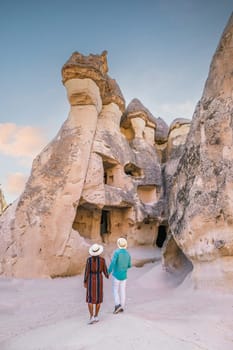 Turkey Cappadocia, happy young couple on vacation in Turkey Cappadocia, Rock Formations in Pasabag Monks Valley, Cappadocia, Turkey
