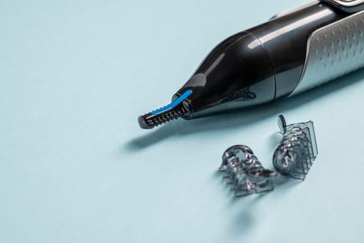 Top view of nose and ear hair trimmer isolated on blue background