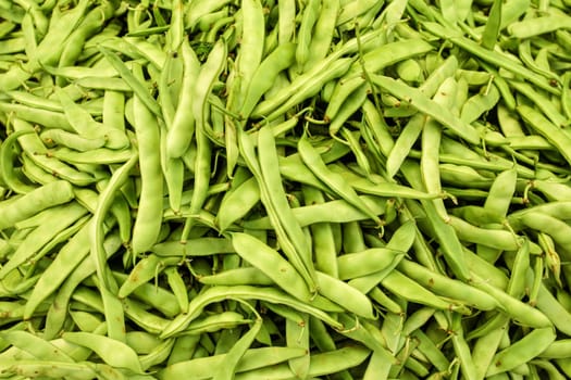 Green beans displayed on food market, shot from above.