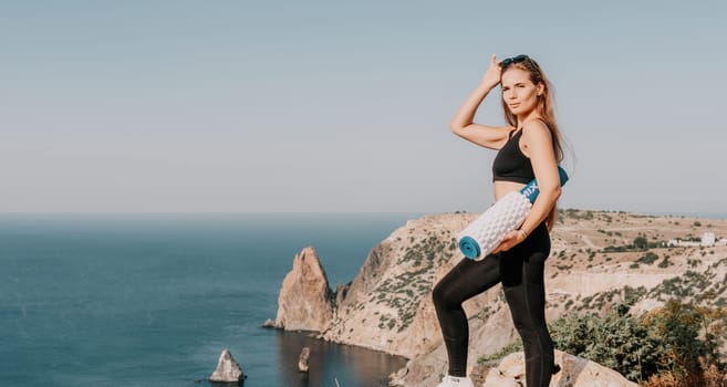 Fitness woman sea. Outdoor workout on yoga mat in park near to ocean beach. Female fitness pilates yoga routine concept. Healthy lifestyle. Happy fit woman exercising with rubber band in park.