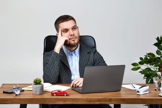 young man using laptop computer for online work at table using laptop