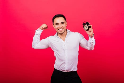 It is your time. Portrait of young man in showing time on a clock watch, ok, thumb up, approve