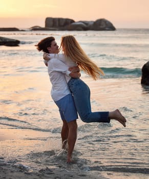 Couple in ocean, freedom and hug, love and commitment in relationship, man swing woman with adventure at beach. Trust, partnership and care with people outdoor, romance and happiness at sunset.