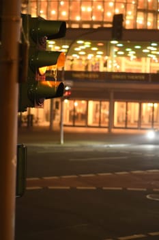 Vertical shot of a red traffic lights at night in Muenster, Germany