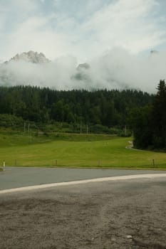View of Leoganger Steinberge with mountain peaks in clouds in Austria